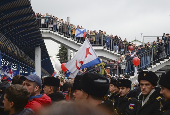 People celebrate the arrival of the train from Russia in Sevastopol, Crimea, after it crossed a bridge linking Russia and the Crimean peninsula Wednesday, Dec. 25, 2019. Ukrainian officials opened a c ...