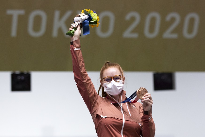 Nina Christen of Switzerland celebrates on the podium after winning the bronze medal in the women&#039;s shooting 10m air rifle final at the 2020 Tokyo Summer Olympics in Tokyo, Japan, on Saturday, Ju ...
