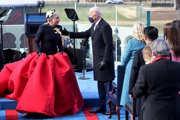 epa08952580 Singer Lady Gaga is greeted by President-elect Joe Biden during the inauguration of Joe Biden as US President in Washington, DC, USA, 20 January 2021. Biden won the 03 November 2020 electi ...