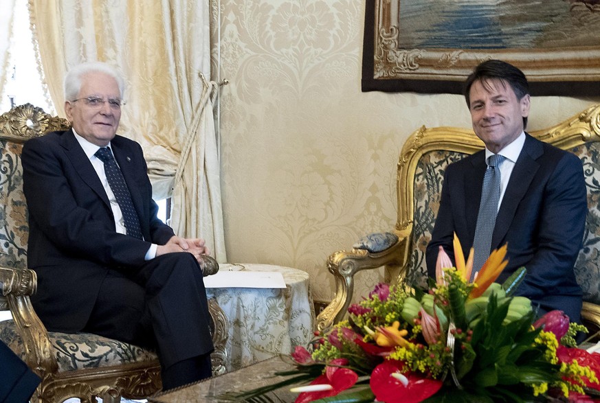 epa06758002 A handout photo made available by the Quirinal Press Office shows Giuseppe Conte (R) meeting with President Sergio Mattarella at the Quirinal Palace in Rome, Italy, 23 May 2018. EPA/PAOLO  ...