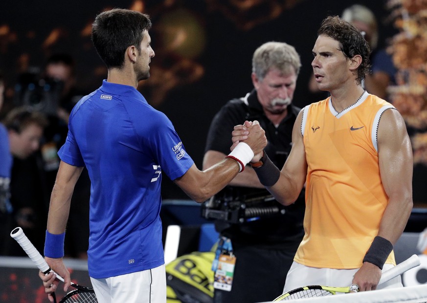 Spain&#039;s Rafael Nadal, right, congratulates Serbia&#039;s Novak Djokovic after Djokovic won the men&#039;s singles final at the Australian Open tennis championships in Melbourne, Australia, Sunday ...