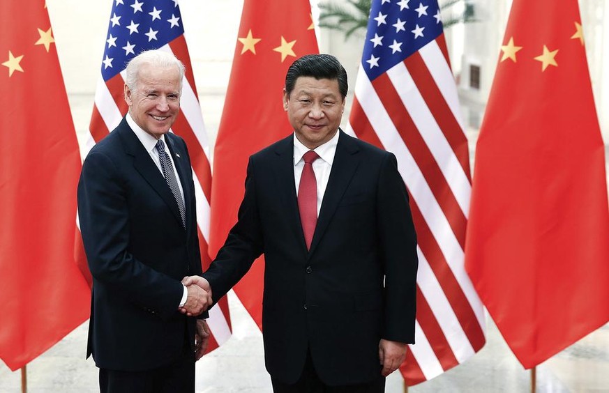 Chinese President Xi Jinping, right, shakes hands with U.S Vice President Joe Biden, left, as they pose for photos at the Great Hall of the People in Beijing, China, Wednesday, Dec. 4, 2013. (AP Photo ...