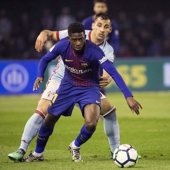 Barcelona&#039;s Ousmane Dembele, foreground, challenges for the ball with RC Celta&#039;s Jonny Otto during a Spanish La Liga soccer match between RC Celta and Barcelona at the Balaidos stadium in Vi ...