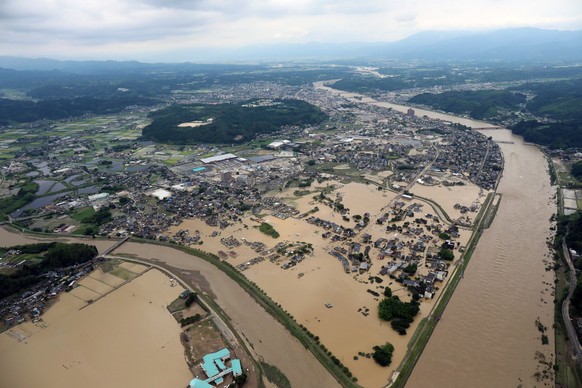 epa08526703 An aerial view shows floods in Hitoyoshi, Kumamoto prefecture, southwestern Japan, 04 July 2020. Local authorities asked the evacuation of more than 200,000 residents in Japan&#039;s south ...