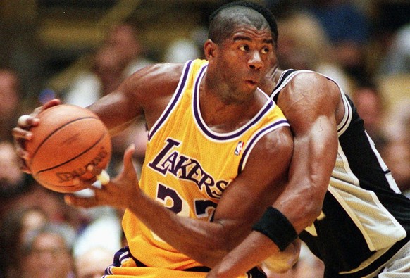 FILE--Los Angeles Lakers&#039; Earvin &quot;Magic&quot; Johnson spins around a pick thrown by San Antonio Spurs&#039; Charles Smith during the first quarter Sunday, April 7, 1996, in Inglewood, Calif. ...