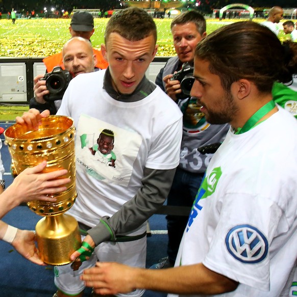 BERLIN, GERMANY - MAY 30: Andre Schuerrle of VfL Wolfsburg, Ivan Perisic of VfL Wolfsburg and Ricardo Rodriguez of VfL Wolfsburg celebrate with the trophy after winning the DFB Cup Final match between ...
