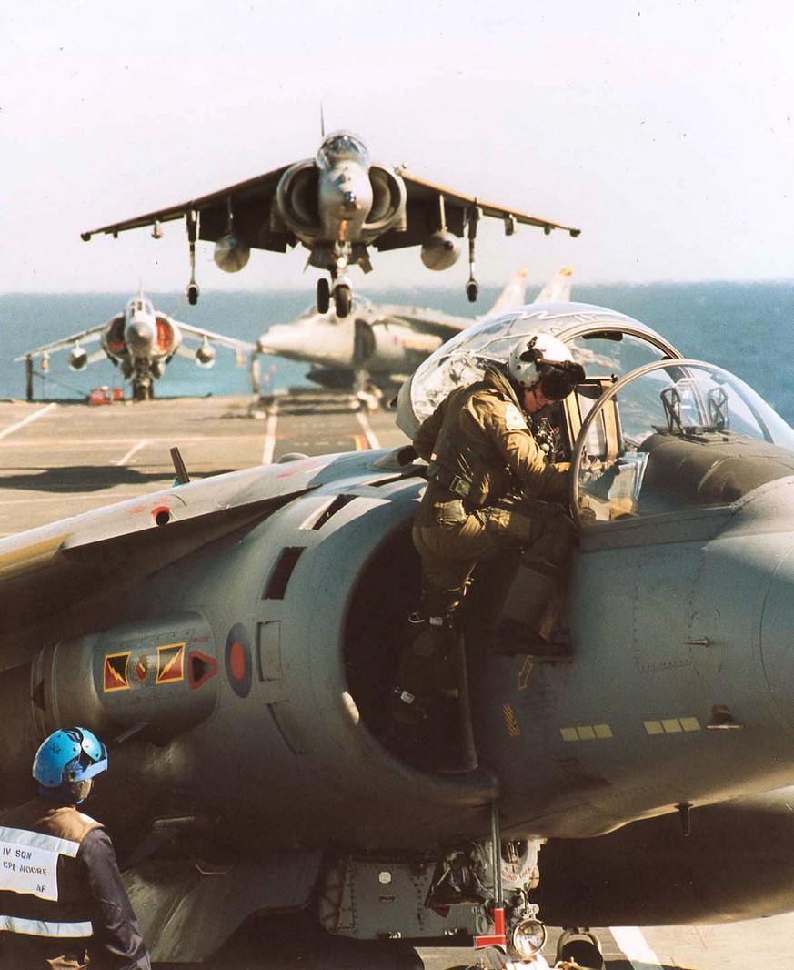 An unidentified pilot from No 4 Squadron of the Royal Air Force, climbs from the cockpit of his Harrier GR7 on the flightdeck of the British aircraft carrier HMS Illustrious, while deployment with Exe ...