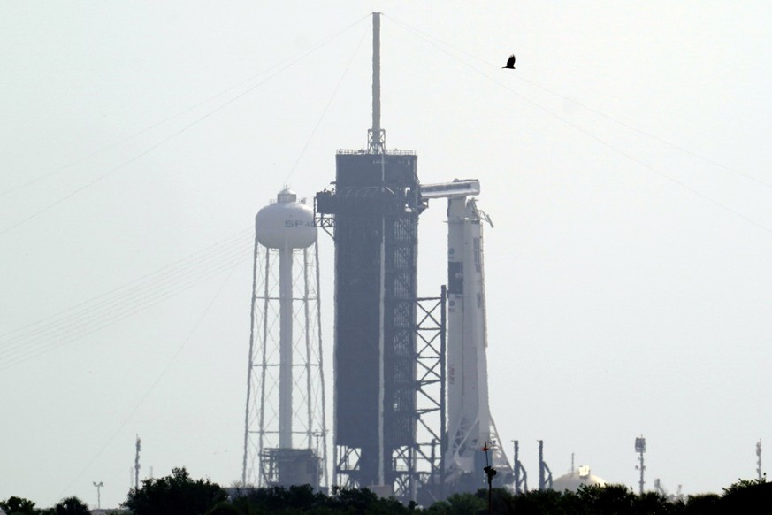 The SpaceX Falcon 9, with the Crew Dragon spacecraft on top of the rocket, sits on Launch Pad 39-A Thursday, May 28, 2020, at Kennedy Space Center in Cape Canaveral, Fla. Wednesday&#039;s planned laun ...