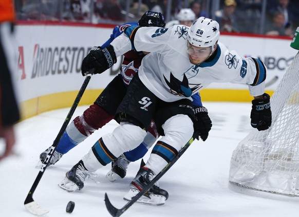 San Jose Sharks right wing Timo Meier, front, wraps around the net for a shot as Colorado Avalanche defenseman Erik Johnson pursues in the second period of Game 6 of an NHL hockey second-round playoff ...