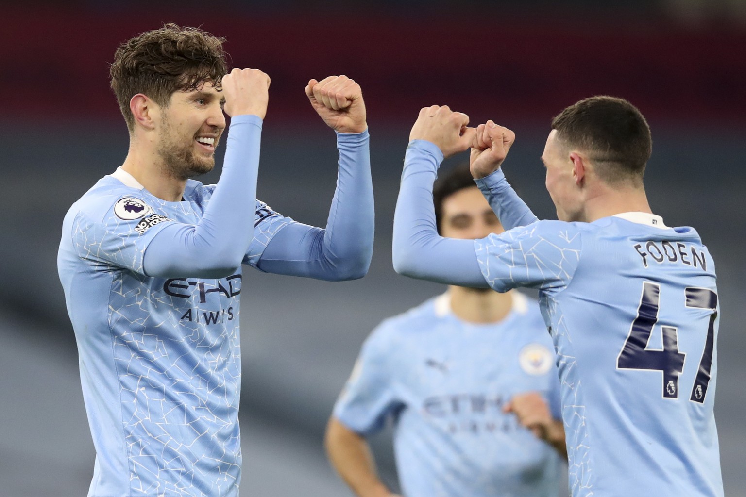 Manchester City&#039;s John Stones, left, celebrates with Phil Foden after scoring his side&#039;s third goal during an English Premier League soccer match between Manchester City and Crystal Palace a ...