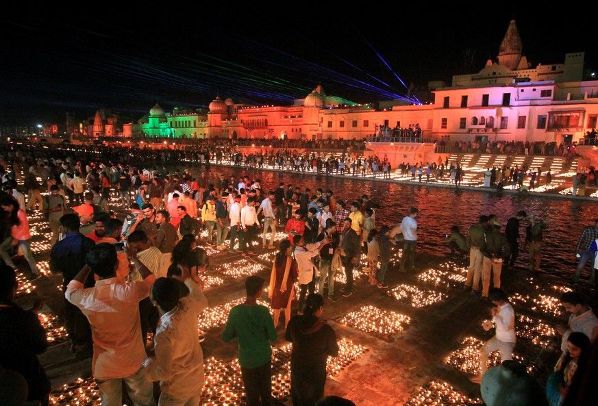 People light lamps on the banks of river Saryu in Ayodhya, India, Friday, Nov. 13, 2020. The northern Indian city of Ayodhya kept its Guinness World Record for a second straight year by lighting more  ...