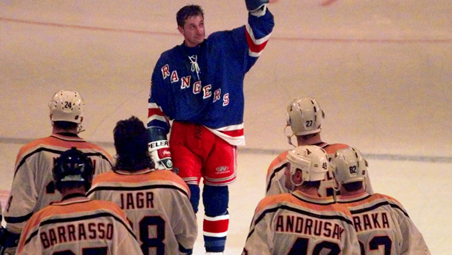 New York Rangers Wayne Gretzky (99) waves to the crowd as he skates towards the Pittsburgh Penguins after playing his last National Hockey Leaque hockey game at New York&#039;s Madison Square Garden S ...