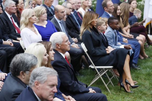 epa08700067 US Vice President Mike Pence (5L) and US Second Lady Karen Pence (4L) sit on one site of the aisle as US First Lady Melania Trump (R) sits with Judge Amy Coney Barrett&#039;s family as she ...