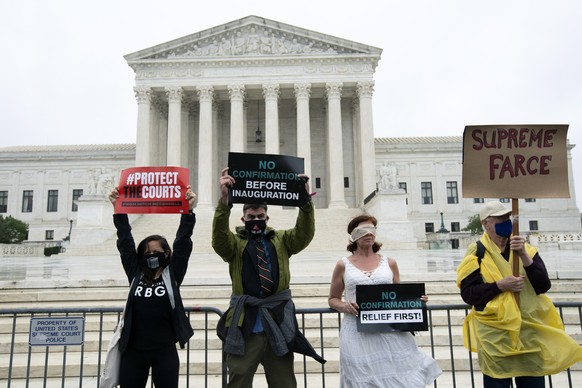 Protesters opposed to the confirmation of President Donald Trump&#039;s Supreme Court nominee Amy Coney Barrett, rally at the Supreme Court in Washington, Monday, Oct. 12, 2020. Barrett&#039;s confirm ...