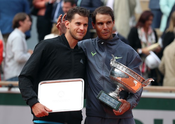 epa07637425 Winner Rafael Nadal of Spain (R) and runner-up Dominic Thiem of Austria pose with their trophies after their men’s final match during the French Open tennis tournament at Roland Garros in  ...