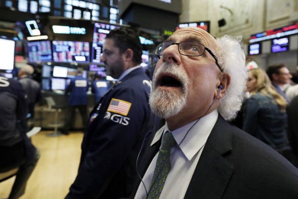Trader Peter Tuchman works on the floor of the New York Stock Exchange, Wednesday, Oct. 10, 2018. The Dow Jones Industrial Average plunged more than 800 points, its worst drop in eight months, led by  ...