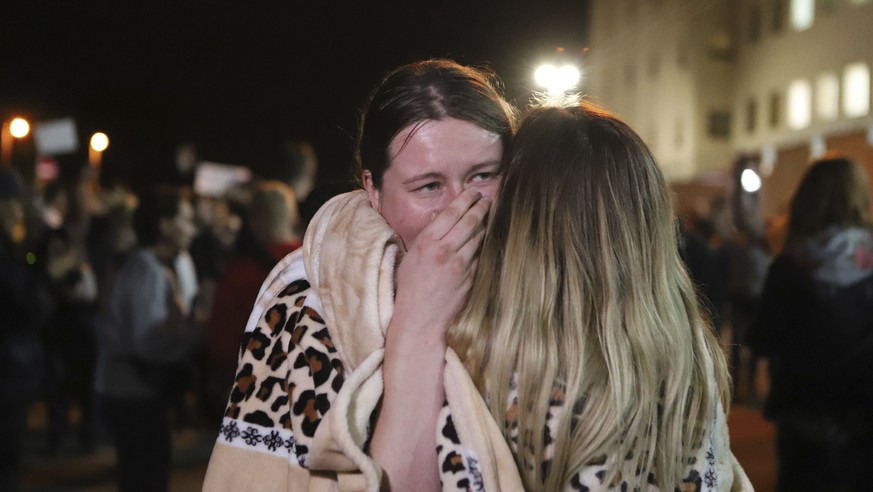 Relatives hug after being released from a detention center where protesters were detained during a mass rally following presidential election in Minsk, Belarus, Friday, Aug. 14, 2020. Nearly 7,000 peo ...