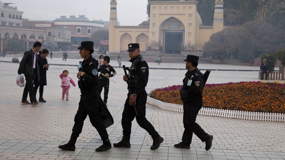 FILE - In this Nov. 4, 2017 file photo, Uighur security personnel patrol near the Id Kah Mosque in Kashgar in western China&#039;s Xinjiang region. Classified documents, leaked to a consortium of news ...