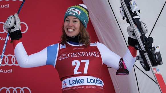 Michelle Gisin, of Switzerland, celebrates her third-place finish on the podium following the women&#039;s World Cup downhill skiing action in Lake Louise, Alberta, Saturday, Dec. 2, 2017. (Jeff McInt ...