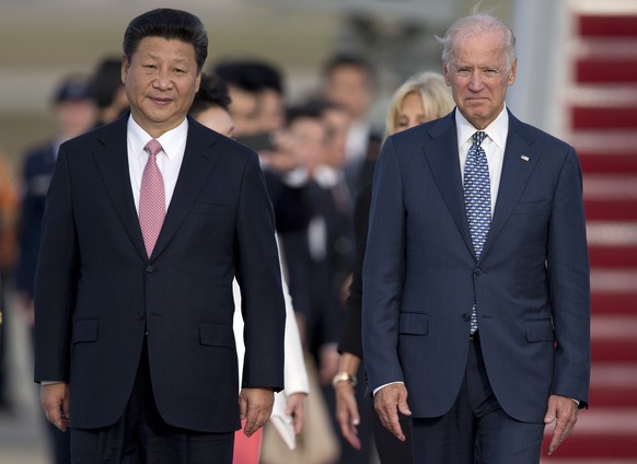 FILE - In this Sept. 24, 2015 file photo, Chinese President Xi Jinping and Vice President Joe Biden walk down the red carpet on the tarmac during an arrival ceremony in Andrews Air Force Base, Md. Chi ...