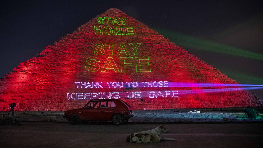 The Ministry of antiquities lights up the pyramids in an expression of support for health workers battling the coronavirus outbreak, Monday, March 30, 2020, in Giza, Egypt. (AP Photo/Nariman El-Mofty)