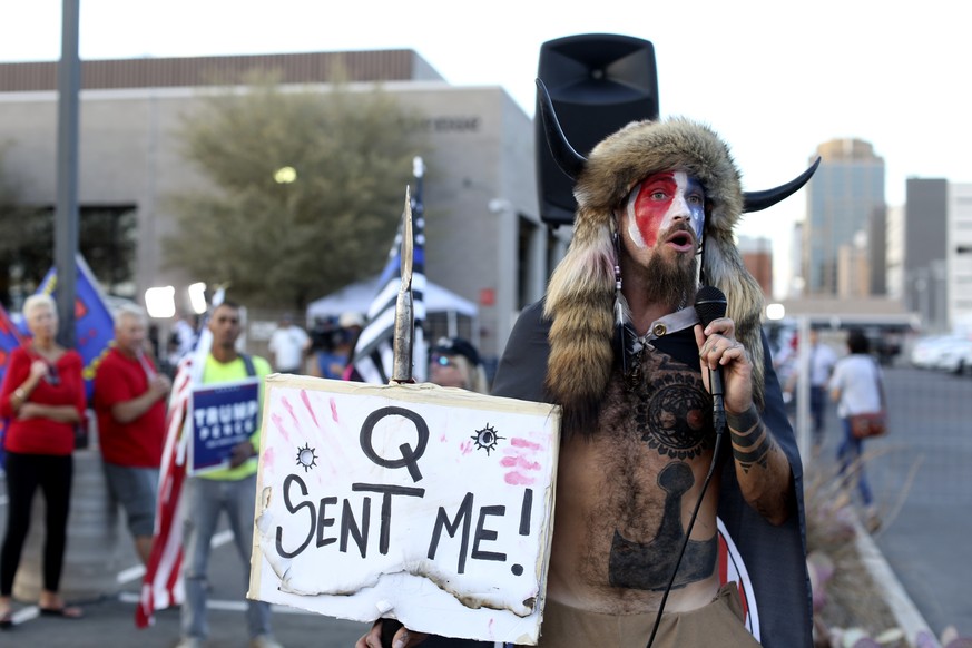 A Qanon believer speaks to a crowd of President Donald Trump supporters outside of the Maricopa County Recorder&#039;s Office where votes in the general election are being counted, in Phoenix, Thursda ...