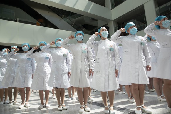 epa08416529 Chinese nurses recite an oath during a ceremony celebrating International Nurses Day at Tongji Hospital in Wuhan, Hubei province, China, 12 May 2020. International Nurses Day is marked on  ...