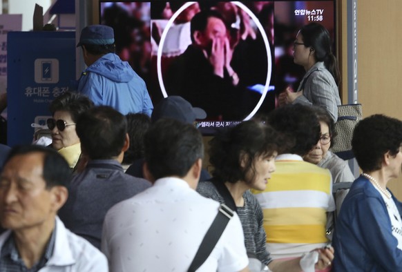 People watch a TV screen showing an image of senior North Korean official Kim Yong Chol in a musical performance by the wives of Korean People&#039;s Army officers in North Korea during a news program ...