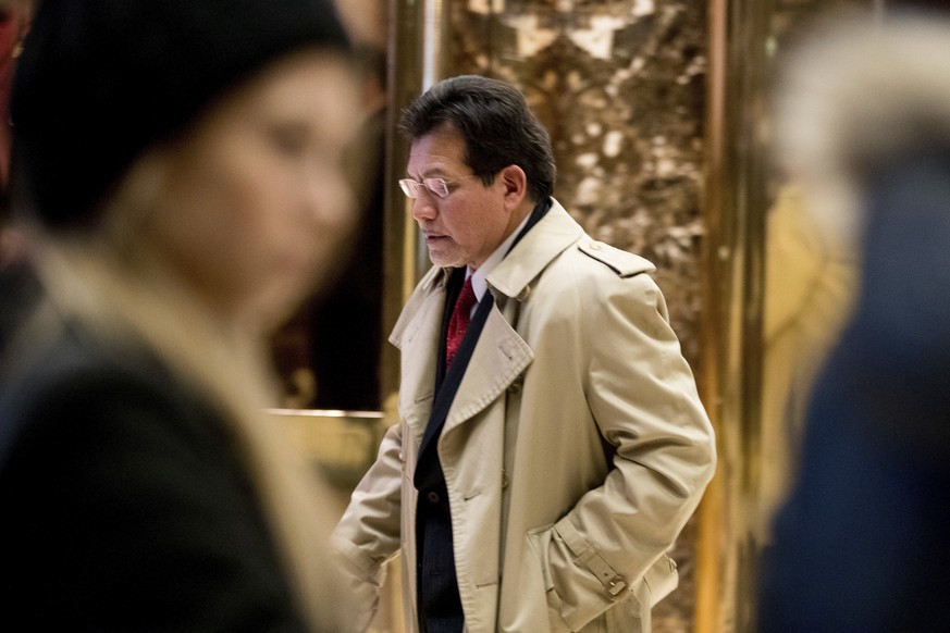 Former Attorney General Alberto Gonzales leaves Trump Tower in New York, Wednesday, Dec. 7, 2016. (AP Photo/Andrew Harnik)