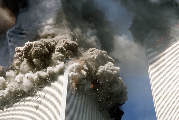 FILE - In this Sept. 11, 2001, file photo, the south tower of the World Trade Center, left, begins to collapse after a terrorist attack on the landmark buildings in New York. Families impacted by the  ...