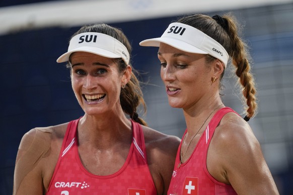 Joana Heidrich, of Switzerland, left, , celebrates with her teammate Anouk Verge-Depre, a winning point against Germany during a women&#039;s beach volleyball match, at the 2020 Summer Olympics, Satur ...