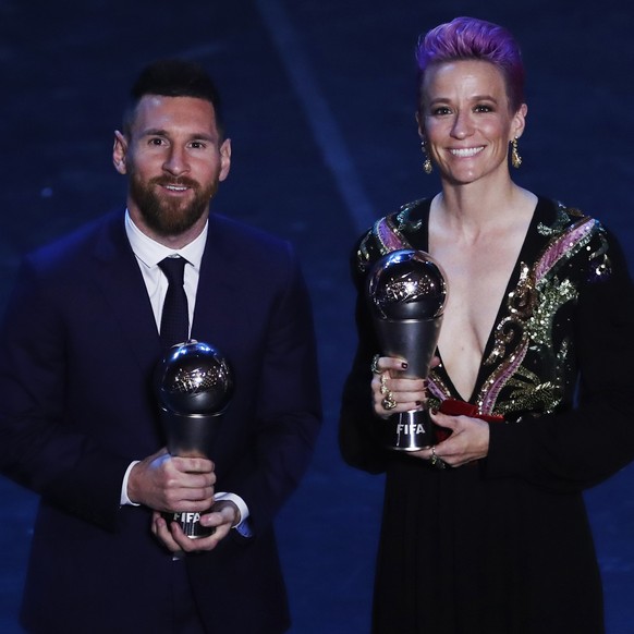 Argentinian Barcelona player Lionel Messi posses with United States forward Megan Rapinoe after they received the Best FIFA Men&#039;s, Women&#039;s player award during the Best FIFA soccer awards cer ...