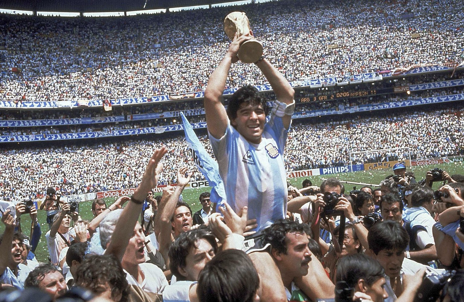 FILE - In this June 29, 1986 file photo, Diego Maradona holds up his team&#039;s trophy after Argentina&#039;s 3-2 victory over West Germany at the World Cup final soccer match at Atzeca Stadium in Me ...