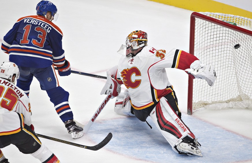 Calgary Flames goalie Jon Gillies (32) is scored on by Edmonton Oilers&#039; Kris Versteeg (13) during the third period of an NHL hockey preseason game Monday, Sept. 26, 2016, in Edmonton, Alberta. (J ...