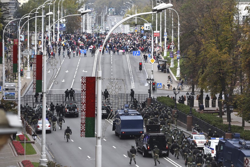Belarusian police block a street during an opposition rally to protest the official presidential election results in Minsk, Belarus, Sunday, Oct. 25, 2020. The demonstrations were triggered by officia ...