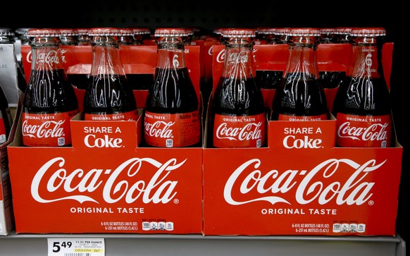 FILE--In this Aug. 8, 2018, file photo, bottles of Coca Cola sit on a shelf in a market in Pittsburgh. The Coca-Cola Company says that it&#039;s &quot;closely watching&quot; the growth of the use of a ...
