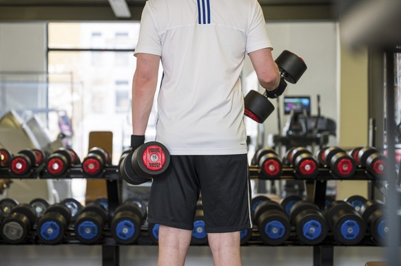 A man works out in a fitness studio in Saarbruecken, Germany, Tuesday, April 6, 2021. As of today, German federal state Saarland will lift some measures to combat the coronavirus pandemic and people w ...