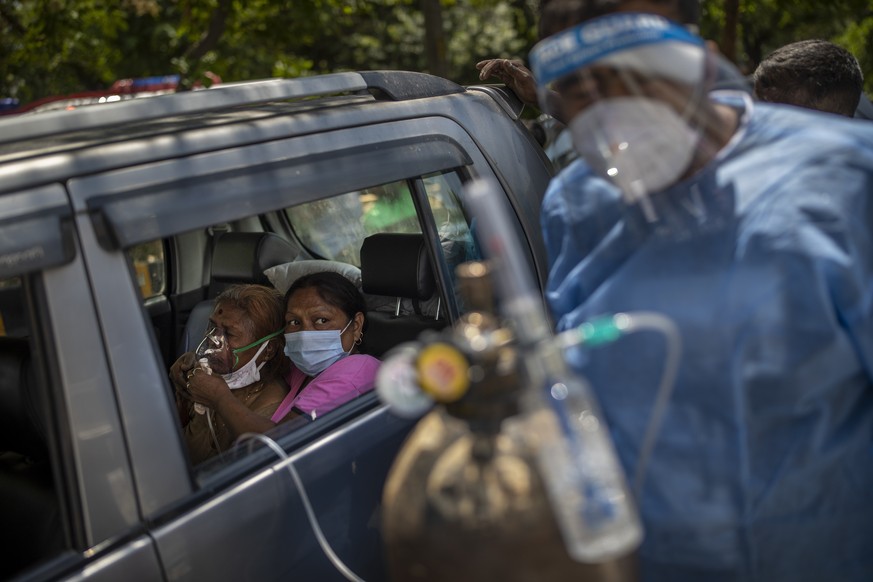A patient receives oxygen inside a car provided by a Gurdwara, a Sikh place of worship, in New Delhi, India, Saturday, April 24, 2021. India