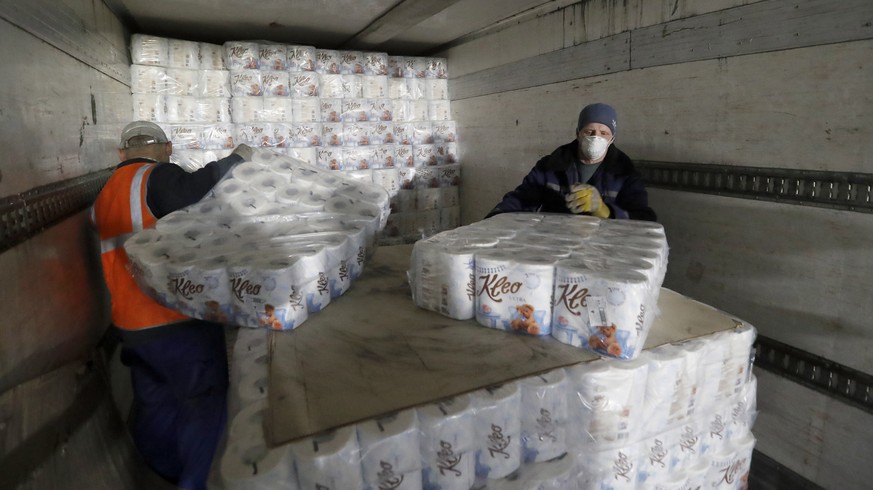 epa08320890 Workers load toilet paper packages into truck on the Syassky Cellulose-Paper Mill in Syasstroy, Leningrad Region, 140 kilometres from St. Petersburg, Russia, 25 March 2020. The capacity of ...