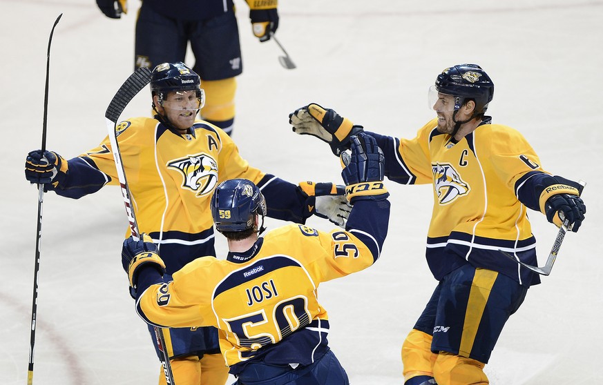 Nashville Predators forward Patric Hornqvist left, of Sweden, and Shea Weber, right, celebrate with Roman Josi (59), of Switzerland, after Josi scored a goal against the Tampa Bay Lightning in the sec ...