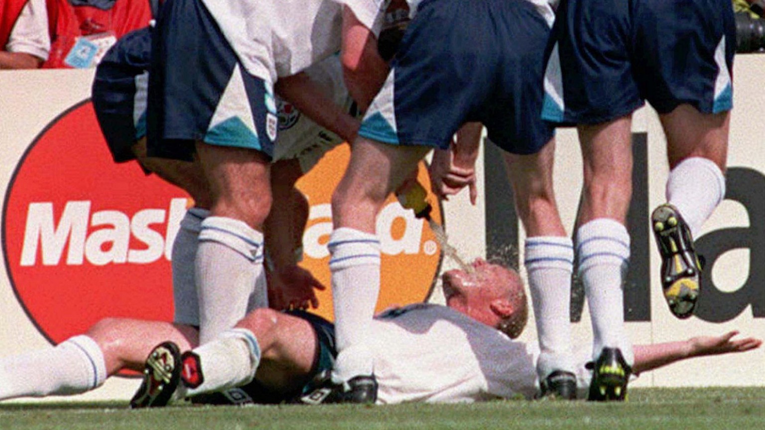 Paul Gascoigne is swamped by England teammates after scoring their second goal during their Euro 96 clash against Scotland, at Wembley, Saturday June 15 1996. England won 2-0. (AP Photo/Adam Butler)