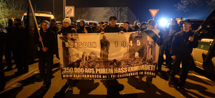epa05157137 Members of a Neo-Nazis group march with a banner, which recalls the night of bombing of 13 February 1945, in Prohlis district of in Dresden, Germany, 12 February 2016. After a relatively s ...