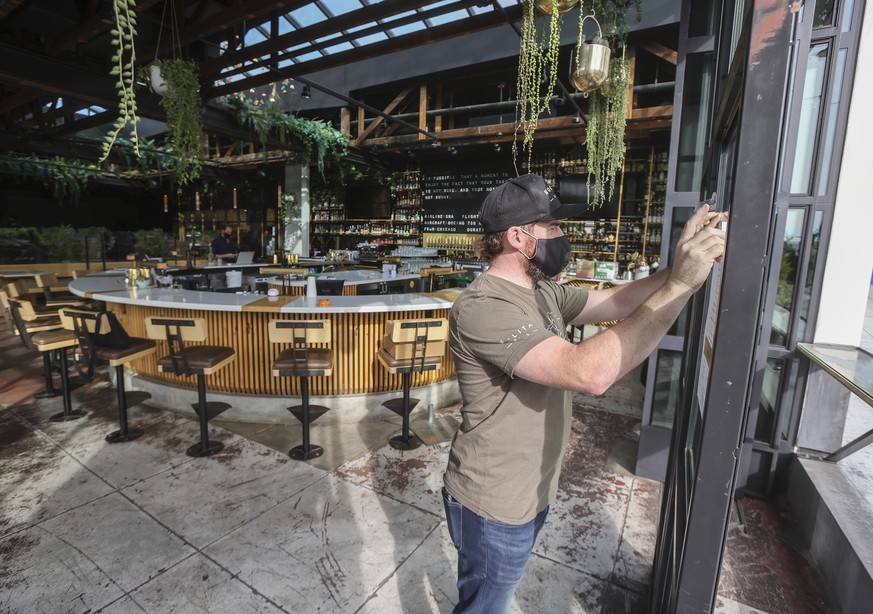 General manager Sean Daley prepares Nolita Hall restaurant to open for takeout service in Little Italy, Thursday, Dec. 17, 2020, in San Diego. On the following day, they expect to reopen for indoor an ...