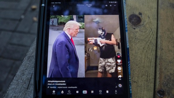 epa08581692 US President Donald Trump is seen on the TikTok app post on a bench in Shanghai, China, 03 August 2020. According to media reports, Microsoft is in talks to buy the US operations of Chines ...
