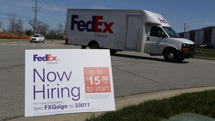 A sign advertising for jobs sits along the roadside outside a FedEx location in Zionsville, Ind., Thursday, April 2, 2020. More than 6.6 million Americans applied for unemployment benefits the week of ...