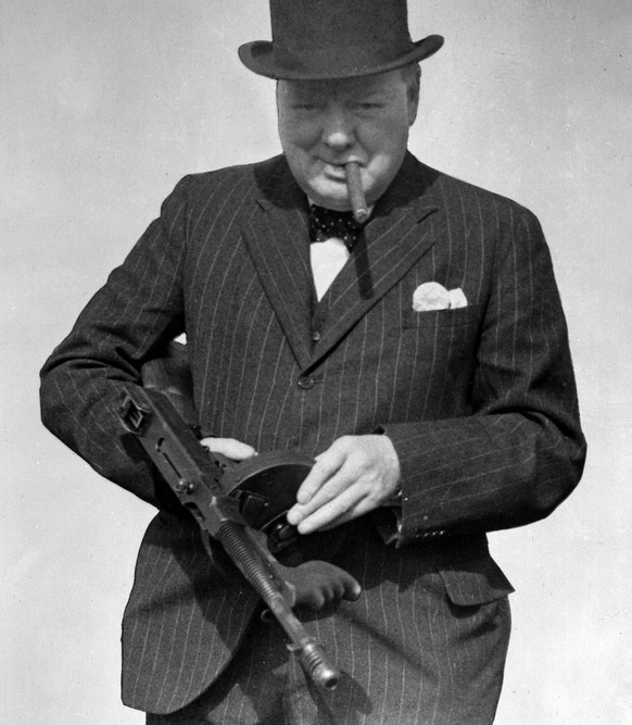 This is a Aug. 1, 1940 photo provided by the British government, Britain&#039;s Prime Minister Winston Churchill tries a Tommy Gun during a visit to north-east England. Churchill Britain&#039;s famous ...
