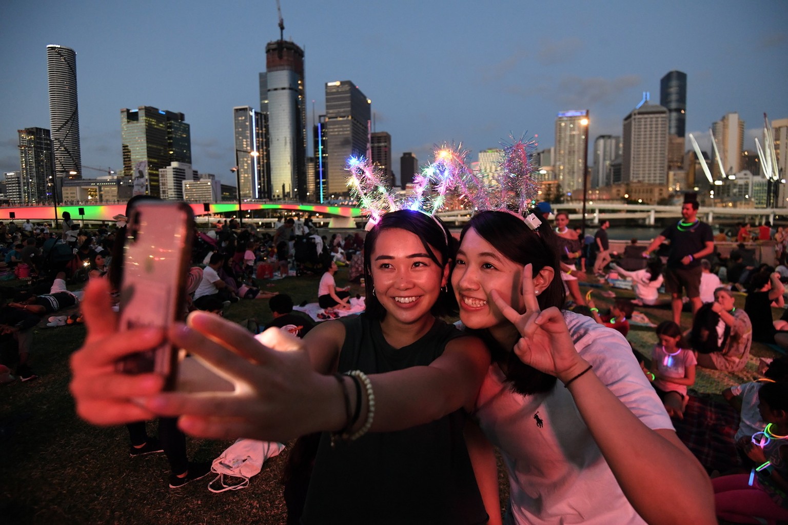 epa08095693 Mizuki (L) and Tsubasa take a selfie as they wait to watch the New Year&#039;s Eve fireworks at Southbank in Brisbane, Australia, 31 December 2019. EPA/DAN PELED AUSTRALIA AND NEW ZEALAND  ...