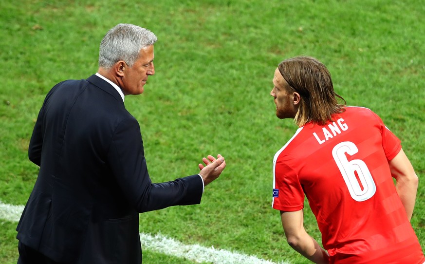 Switzerland coach Vladimir Petkovic speaks with Michael Lang during the Euro 2016 Group A soccer match between Switzerland and France at the Pierre Mauroy stadium in Villeneuve dAscq, near Lille, Fra ...