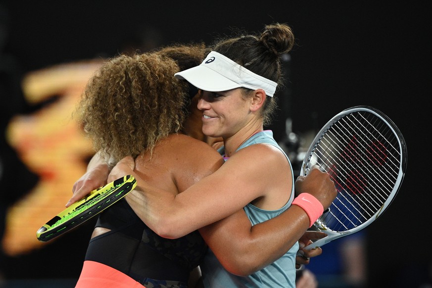 epa09025480 Naomi Osaka of Japan hugs Jennifer Brady of the United States after winning the women&#039;s singles final on day 13 of the Australian Open tennis tournament at Rod Laver Arena in Melbourn ...
