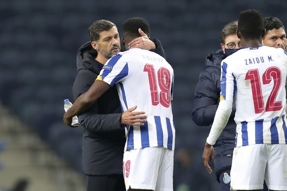 Porto&#039;s head coach Sergio Conceicao embraces Porto&#039;s Chancel Mbemba at the end of the Champions League group C soccer match between FC Porto and Manchester City at the Dragao stadium in Port ...